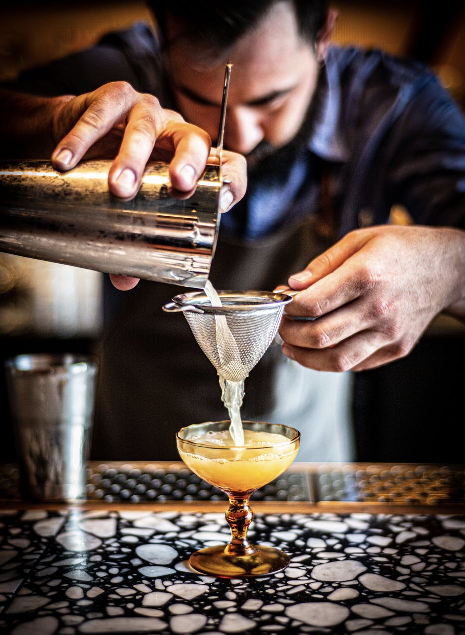 a bartender making a cocktail